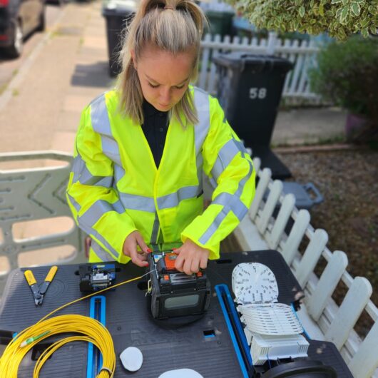 Woman technician at SDU Telecoms performing fibre splicing