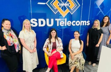 A dynamic team of women working at SDU Telecoms, both in the office and field operations.