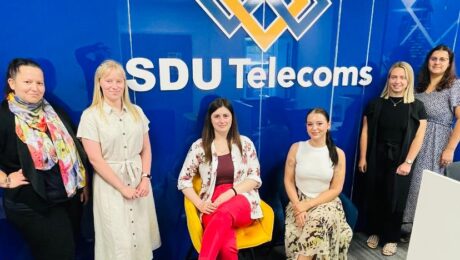 A dynamic team of women working at SDU Telecoms, both in the office and field operations.