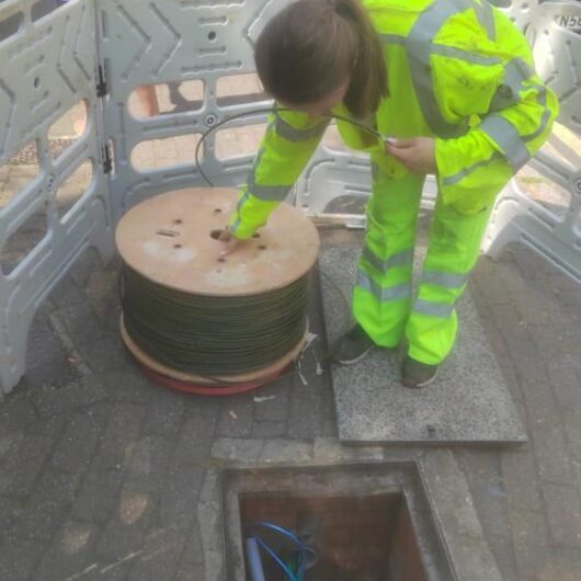 Woman engineer at SDU Telecoms working on-site.