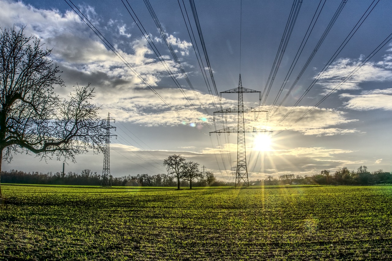 SDU Telecoms Wayleave Solutions: Power poles on landscape with sunset